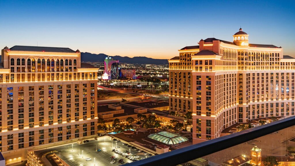 A scenic view of Las Vegas with a tow truck in the foreground — save money on towing Las Vegas