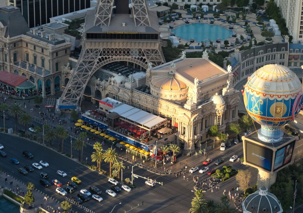 A close-up view of a tow truck assisting a vehicle in front of a popular Las Vegas hotel. — tow truck las vegas strip
