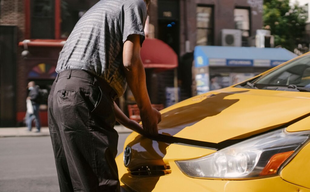 A mechanic inspecting a vehicle on the side of the road, illustrating roadside safety. — las vegas road safety
