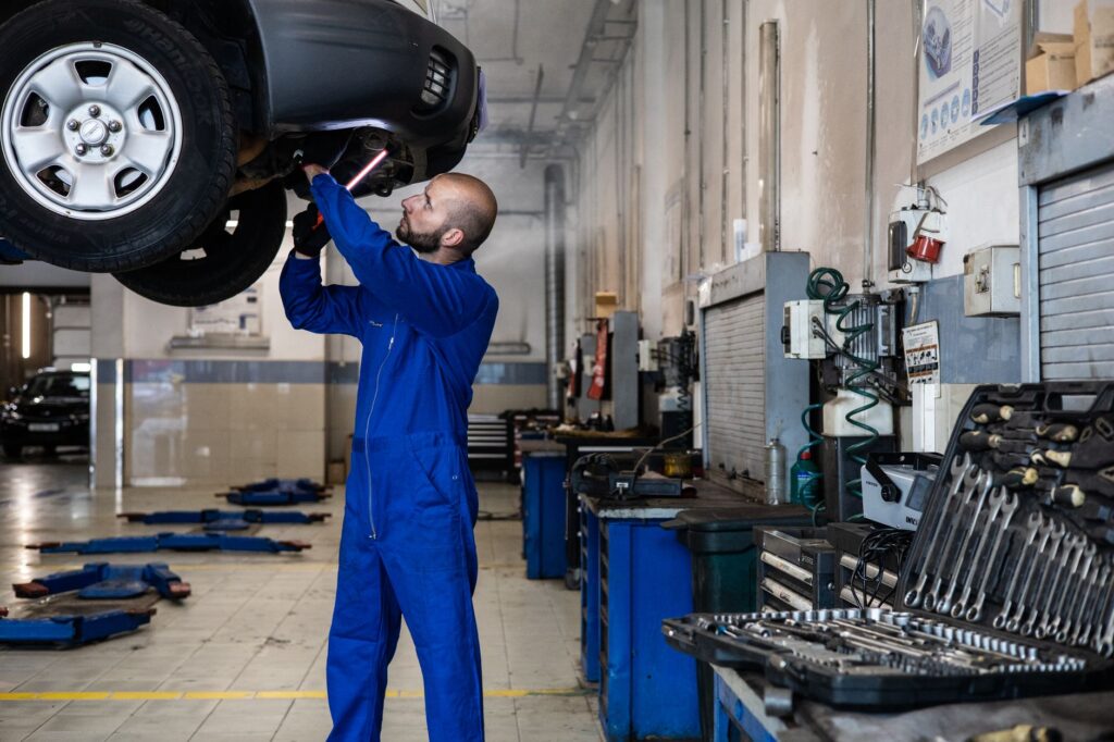 A mechanic inspecting a vehicle with tools laid out. — roadside assistance las vegas
