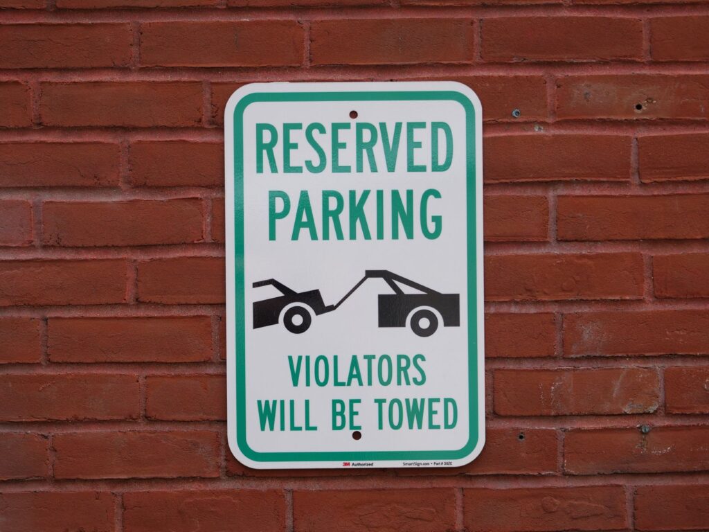 A sign indicating towing restrictions in a Las Vegas parking lot — why cars get towed