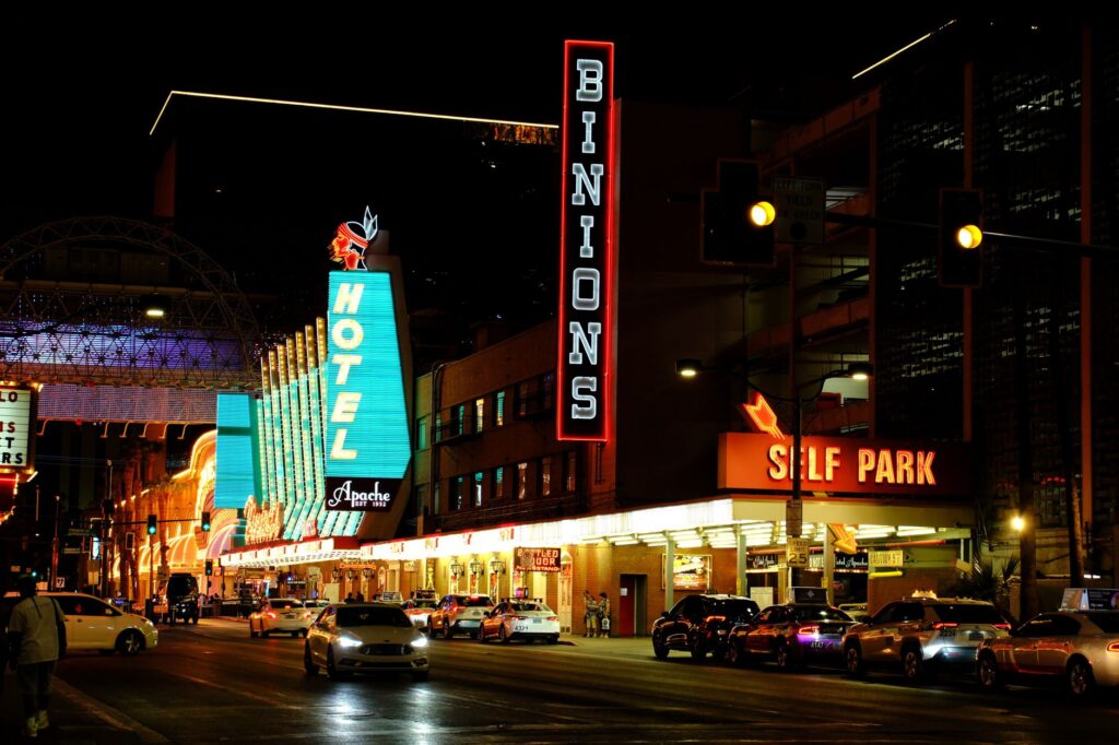 A tow truck parked on a busy Las Vegas street with neon lights in the background. — best towing company las vegas