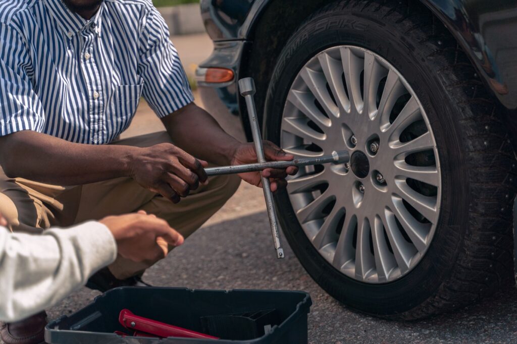 Image of a roadside assistance vehicle helping a driver with a flat tire. — roadside assistance vs towing