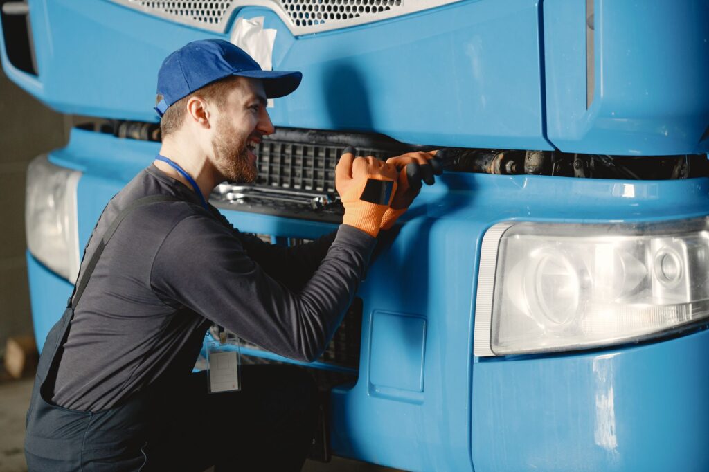 A driver receiving assistance from a roadside technician. — roadside assistance faq
