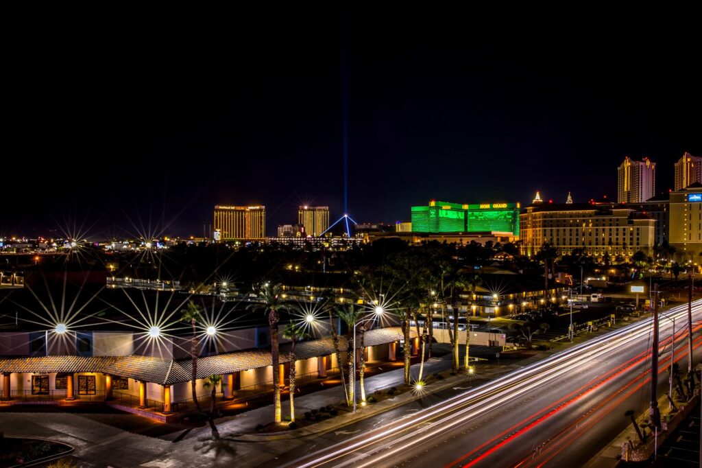 A nighttime view of Las Vegas with a tow truck in action — tow truck dispatch las vegas